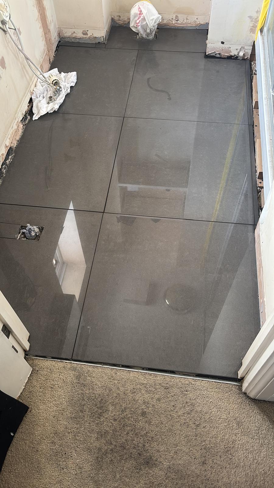 Large-format floor tiles laid in a bathroom