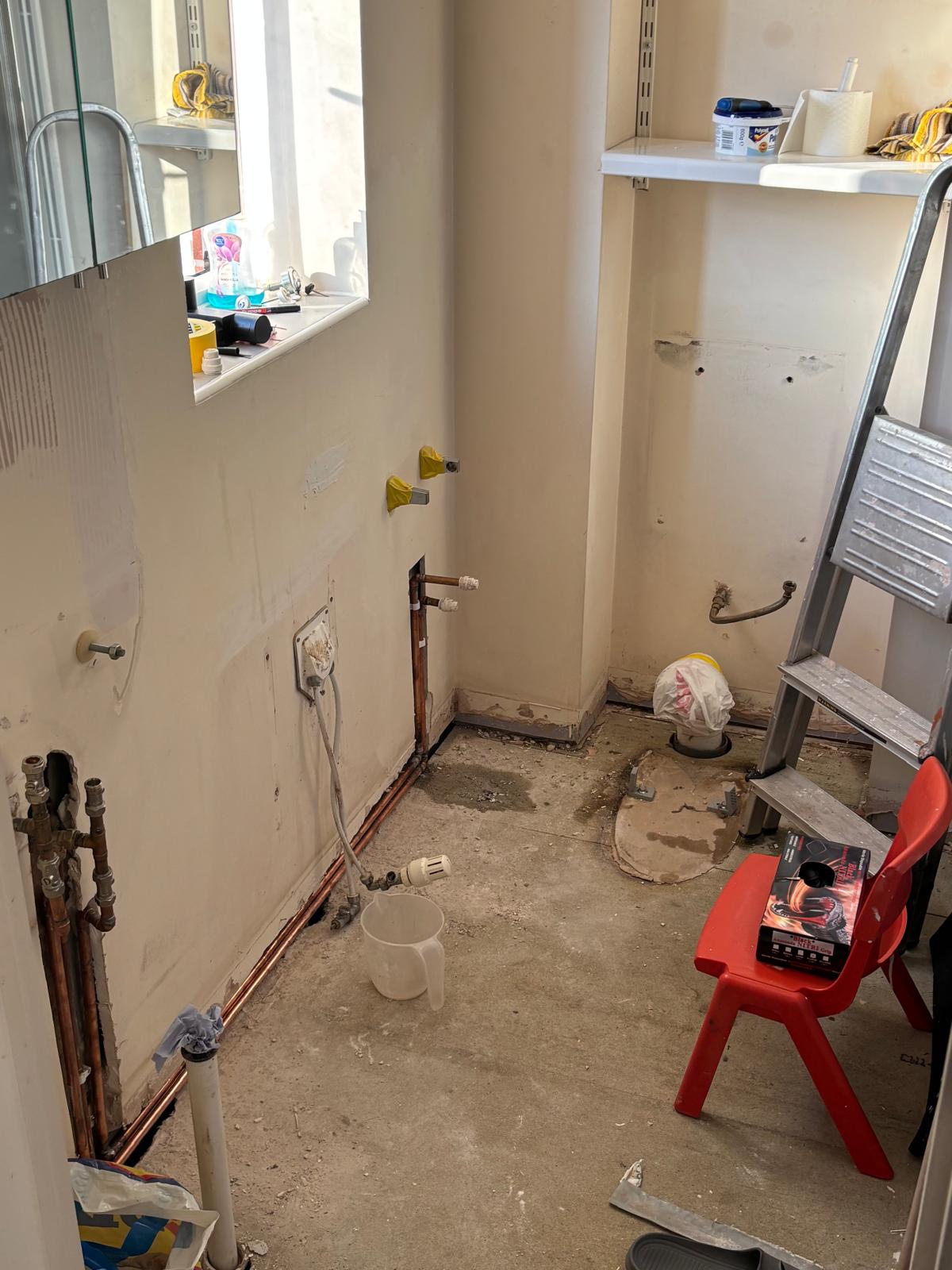 Bathroom stripped back to bare walls and floor