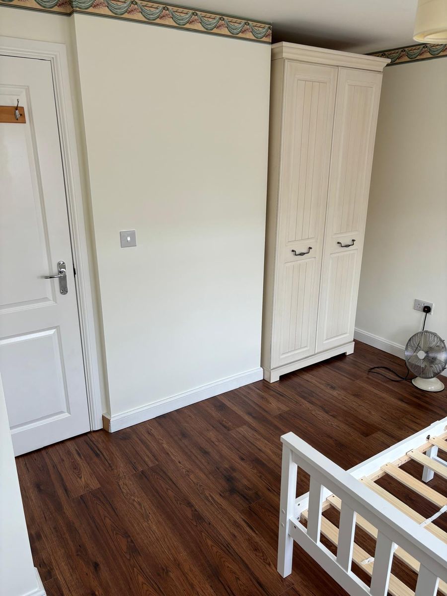 Finished bedroom flooring running up to the wardrobe and doorway