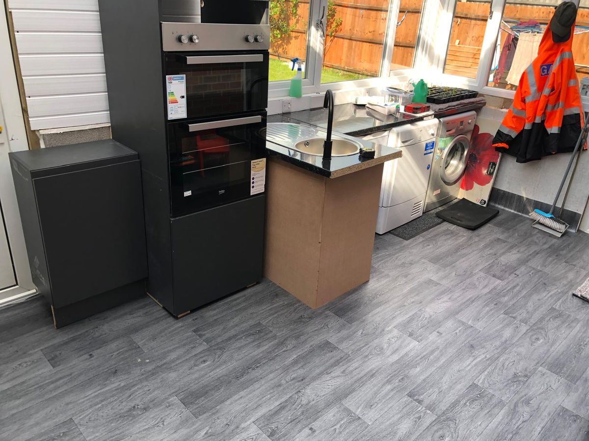 Conservatory converted into a fitted utility and kitchen space