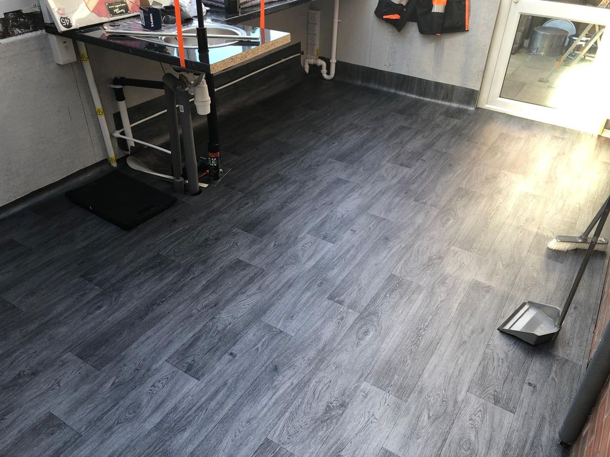 Wood-effect flooring laid throughout a converted conservatory