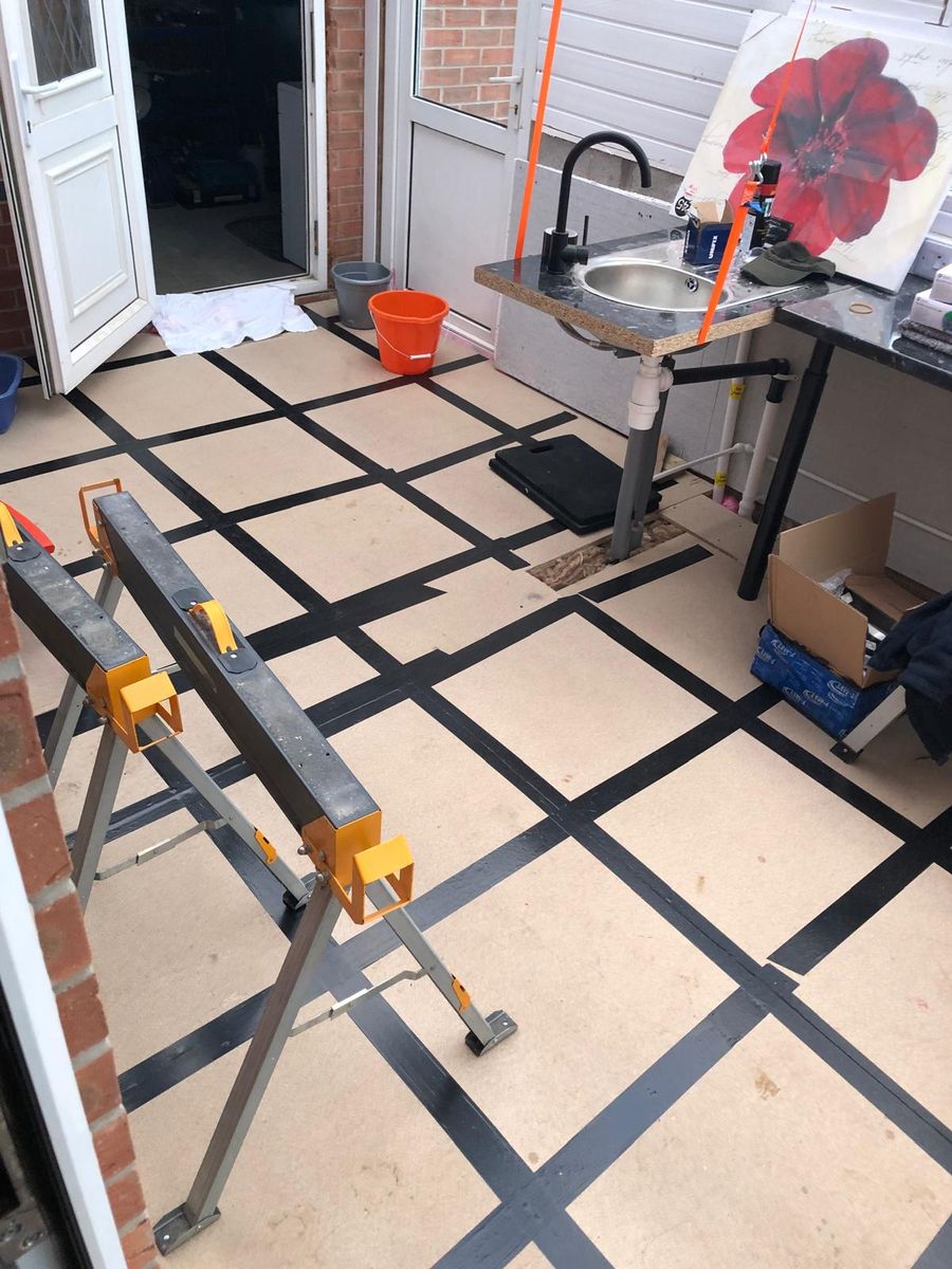 Boarded subfloor with taped joints and sink pipework run in