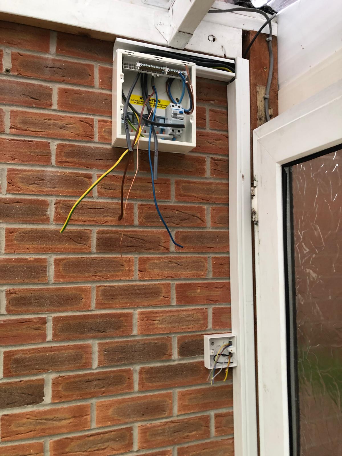Consumer unit enclosure with circuits pulled through, mid-installation